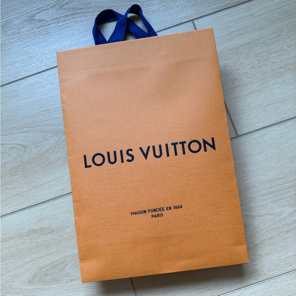 Louis Vuitton orange shopping bag with blue handles